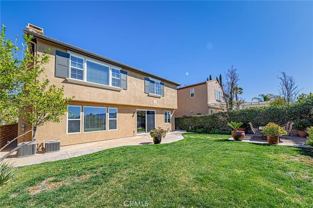 back of house with a yard, a patio, stucco siding, central AC, and fence