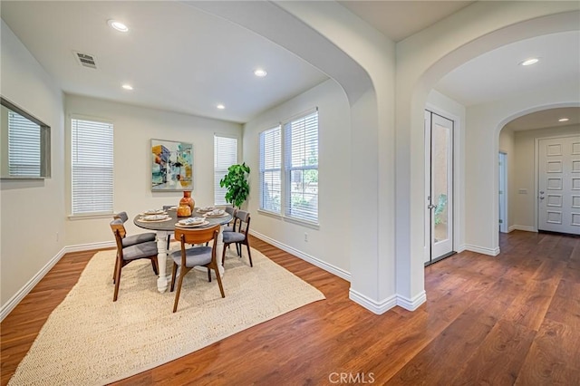 dining area featuring baseboards, dark wood-style flooring, visible vents, and recessed lighting