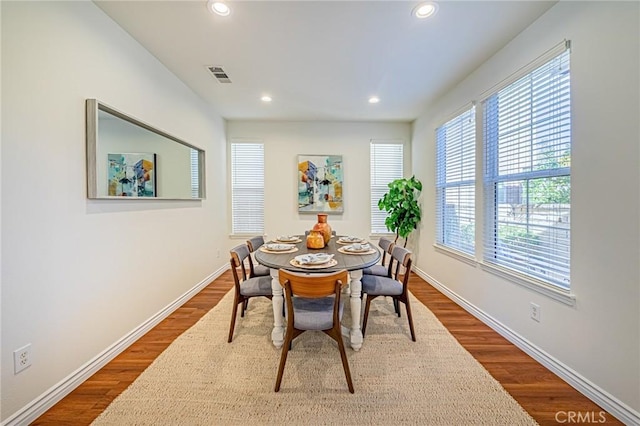 dining area featuring recessed lighting, wood finished floors, and baseboards