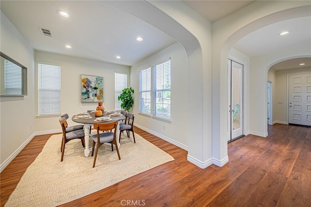 dining room with baseboards, dark wood finished floors, visible vents, and recessed lighting