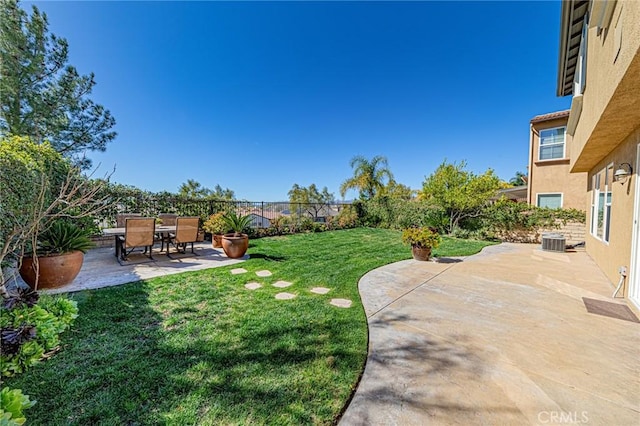 view of yard featuring a patio area, a fenced backyard, and central air condition unit