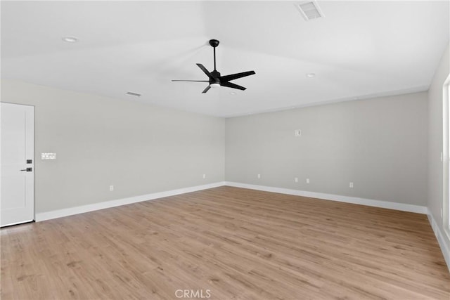 spare room with light wood-style floors, visible vents, ceiling fan, and baseboards