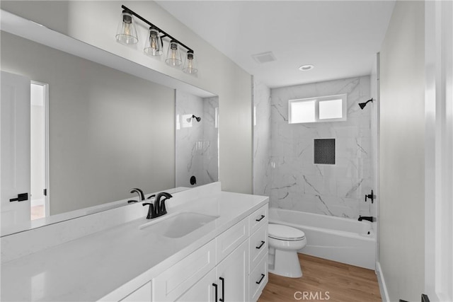 bathroom with shower / bathing tub combination, vanity, toilet, and wood finished floors