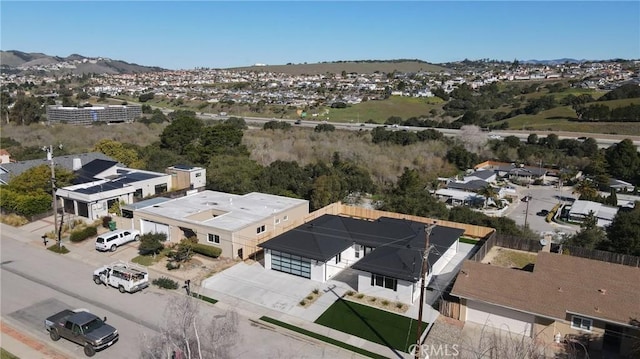 drone / aerial view featuring a residential view and a mountain view