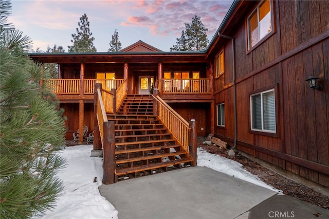 exterior entry at dusk featuring covered porch