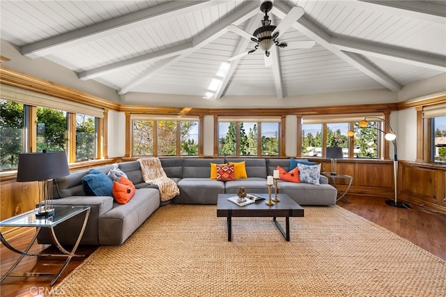 sunroom / solarium featuring vaulted ceiling with beams, plenty of natural light, and a ceiling fan