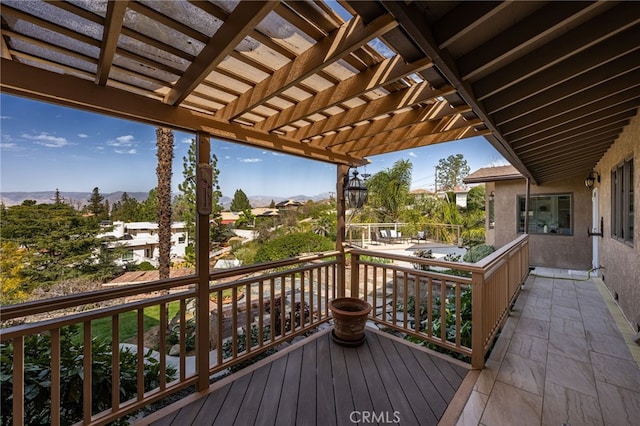 wooden terrace with a mountain view and a pergola