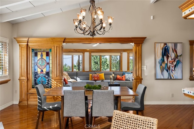 dining room with vaulted ceiling with beams, wood finished floors, and baseboards