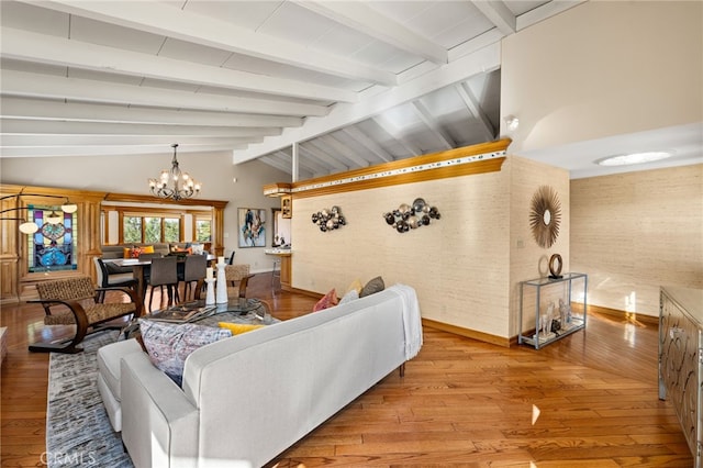 living room featuring lofted ceiling with beams, light wood finished floors, and an inviting chandelier