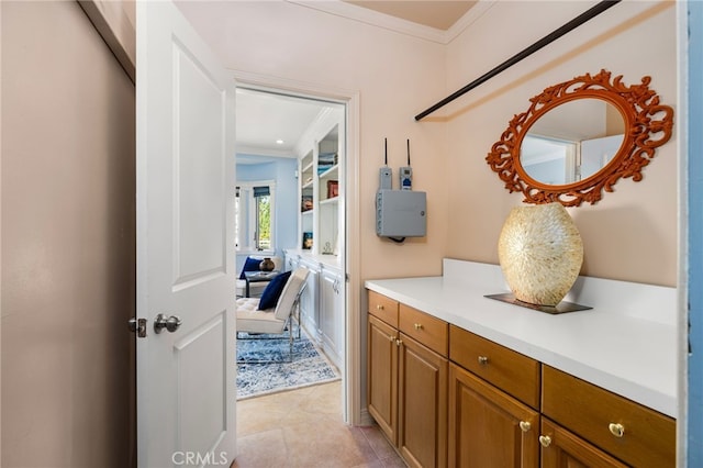 hallway featuring light tile patterned floors and crown molding