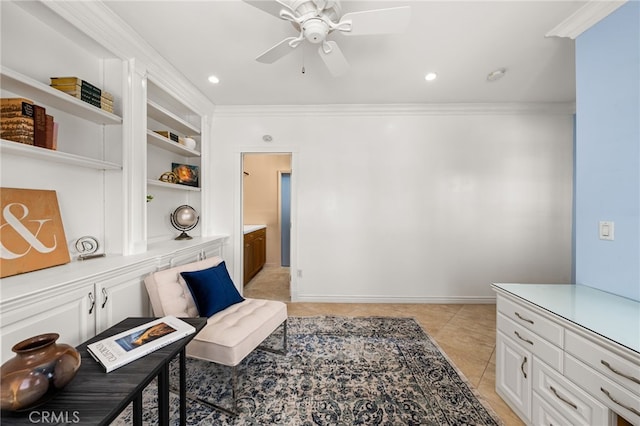 sitting room featuring built in features, crown molding, light tile patterned flooring, ceiling fan, and baseboards