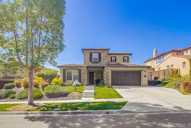 view of front facade with driveway, an attached garage, and stucco siding