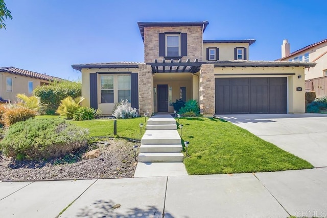 view of front of home featuring a garage, driveway, a front yard, and stucco siding