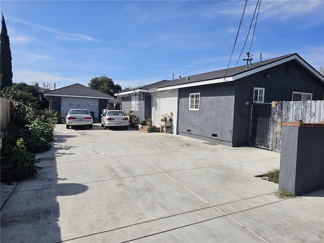 exterior space featuring crawl space, fence, and stucco siding