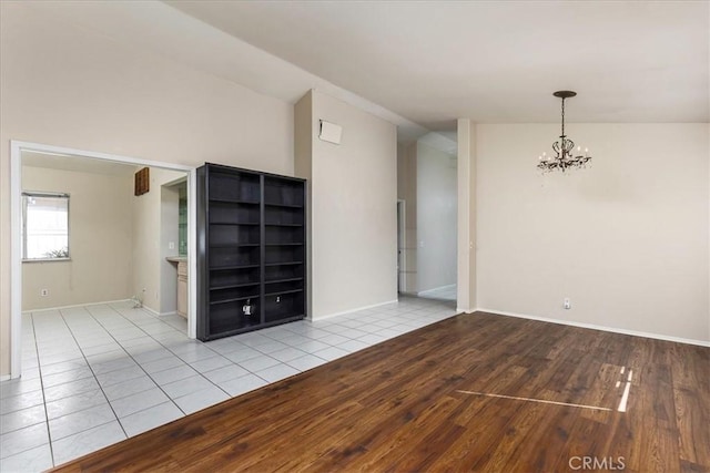 40292 Corte Delfin, Murrieta, CA 92562 - unfurnished room featuring wood finished floors and a chandelier