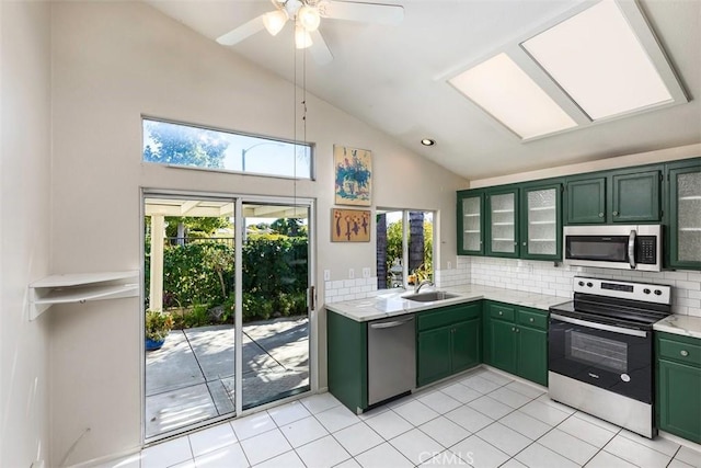 40292 Corte Delfin, Murrieta, CA 92562 - kitchen with tasteful backsplash, glass insert cabinets, green cabinets, appliances with stainless steel finishes, and a sink