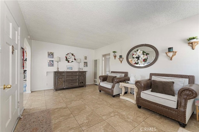 sitting room with light tile patterned flooring and a textured ceiling