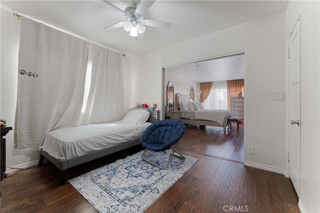 bedroom with a ceiling fan, baseboards, and hardwood / wood-style flooring