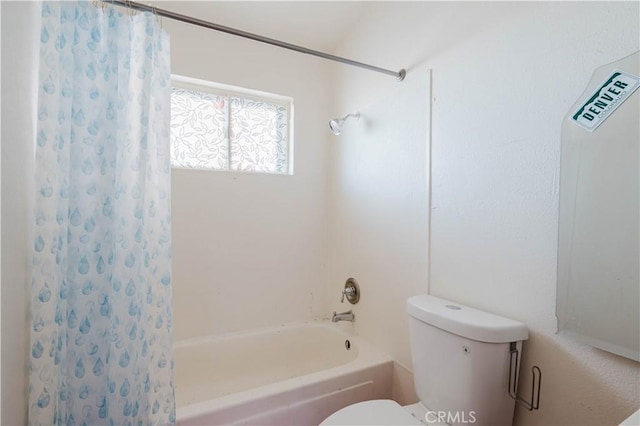 bathroom with shower / bath combo with shower curtain and toilet