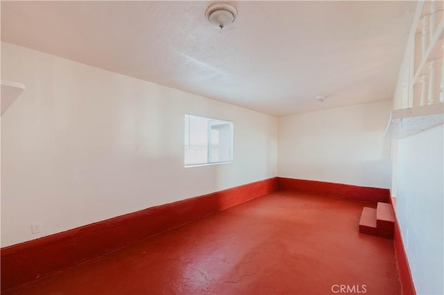 unfurnished room with concrete floors