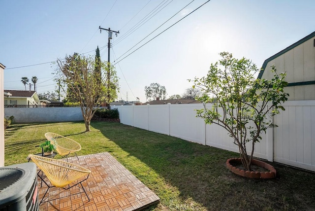 view of yard with central AC, a patio, and a fenced backyard