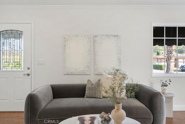 living room featuring plenty of natural light, wood finished floors, and crown molding