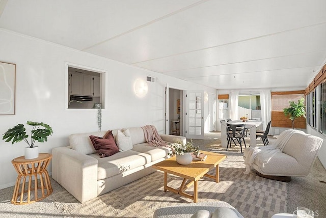 living area featuring light colored carpet and visible vents