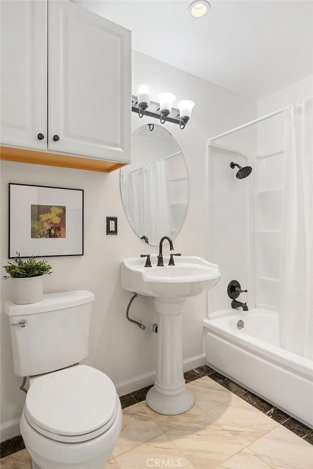 full bathroom with marble finish floor, toilet, shower / bathtub combination with curtain, and baseboards