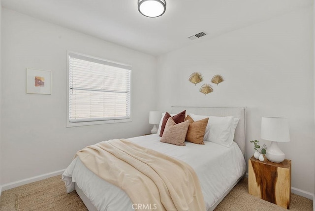 carpeted bedroom featuring visible vents and baseboards