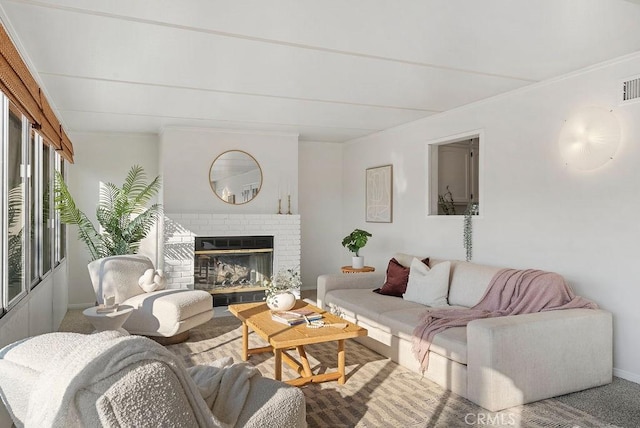 carpeted living room with a fireplace and visible vents