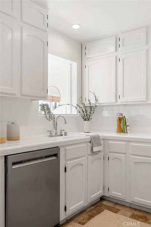 kitchen with white cabinetry, light countertops, and dishwasher