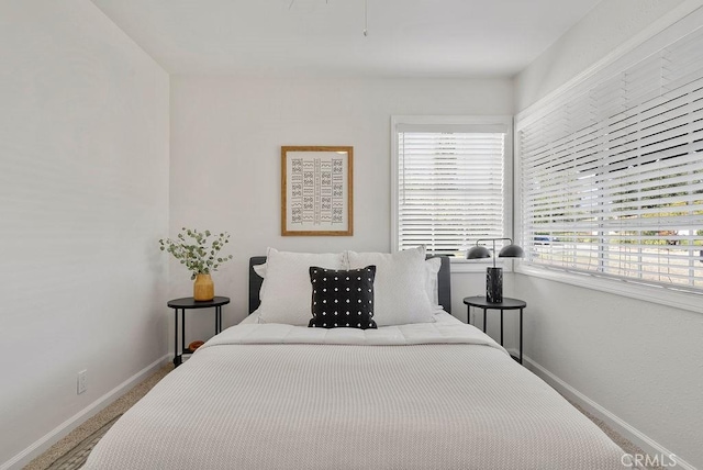 carpeted bedroom with baseboards