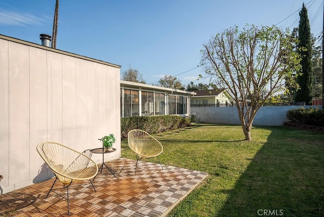 view of yard featuring a sunroom and fence