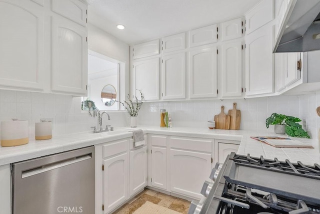 kitchen with light countertops, dishwasher, ventilation hood, and white cabinetry