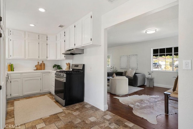 kitchen featuring light countertops, open floor plan, white cabinets, gas range, and under cabinet range hood