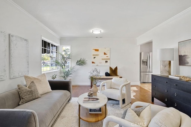 living area with light wood-style floors, baseboards, and crown molding