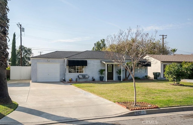 ranch-style home with an attached garage, fence, driveway, stucco siding, and a front yard