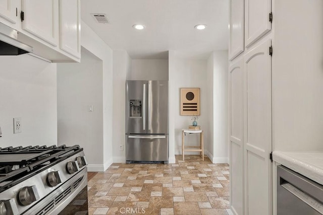 kitchen featuring visible vents, white cabinetry, stainless steel appliances, and light countertops