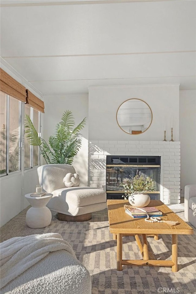 living room with a fireplace and carpet flooring