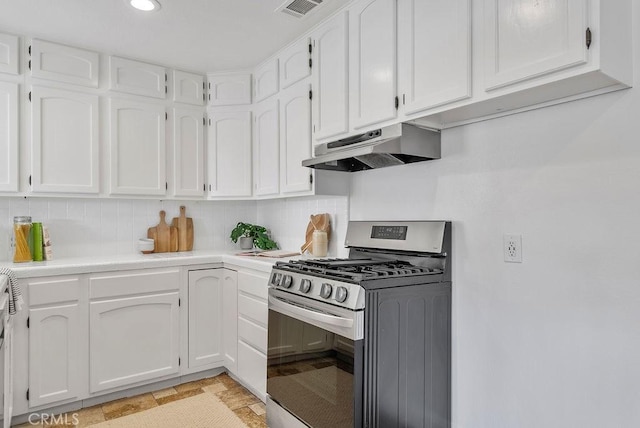 kitchen featuring stainless steel gas stove, tasteful backsplash, light countertops, under cabinet range hood, and white cabinetry