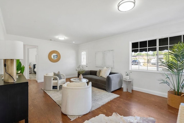 living room featuring crown molding, visible vents, dark wood finished floors, and baseboards