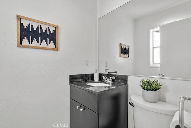 bathroom featuring toilet and vanity