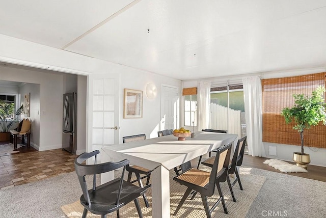 dining space featuring baseboards and stone finish floor