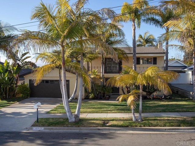 view of front of property featuring a front yard, a garage, and stucco siding