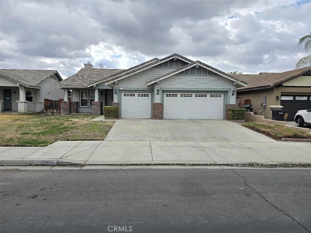 view of front facade with a front yard, brick siding, driveway, and an attached garage