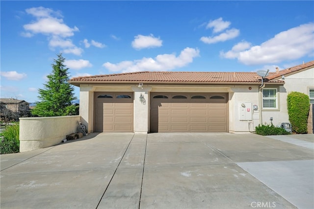 garage featuring concrete driveway