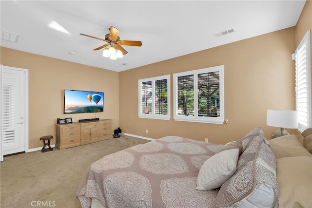 bedroom with light carpet, multiple windows, and visible vents