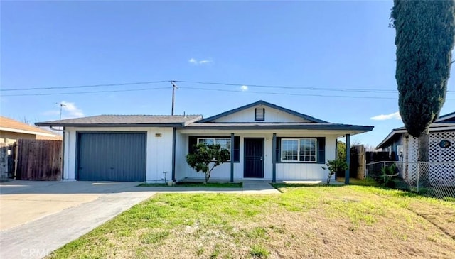 ranch-style home with concrete driveway, a front lawn, an attached garage, and fence