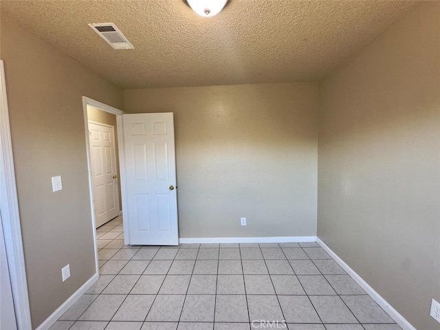 unfurnished room with baseboards, visible vents, and light tile patterned flooring