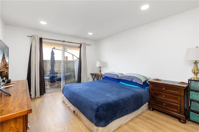 bedroom with recessed lighting, wood finished floors, and access to exterior